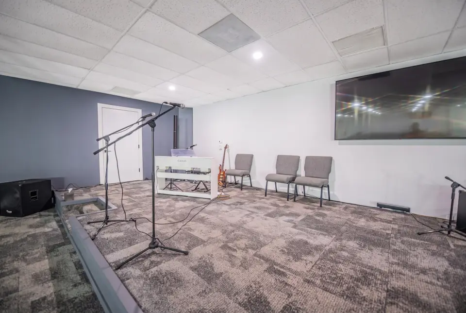 Microphones and instruments set on the Sacred Farewells stage with the rows of chairs ready